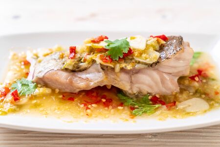 Steamed Grouper Fish Fillet with Chili Lime Sauce in lime dressing - Asian food styleの写真素材