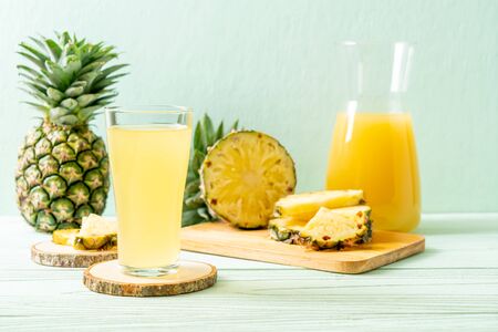 fresh pineapple juice on wood backgroundの写真素材