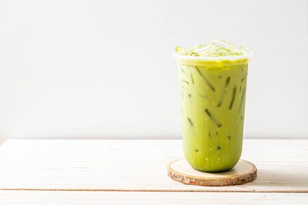 iced matcha latte green tea on wood background