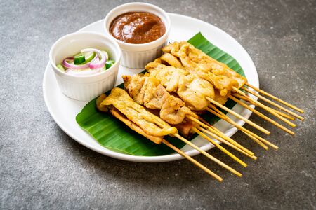 Pork satay - Grilled pork served with peanut sauce or sweet and sour sauce - Asian food styleの写真素材