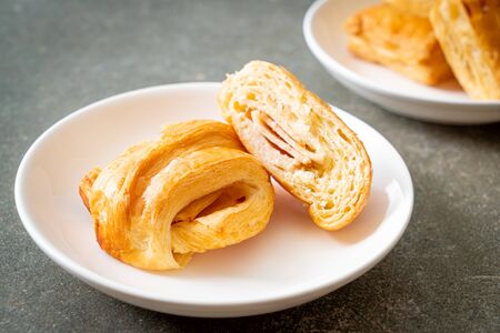 Homemade ham cheese croissant on white plateの写真素材