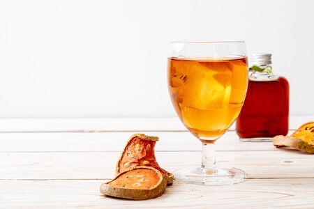 Bael Fruit Herbal Drink Glass on Woodの写真素材