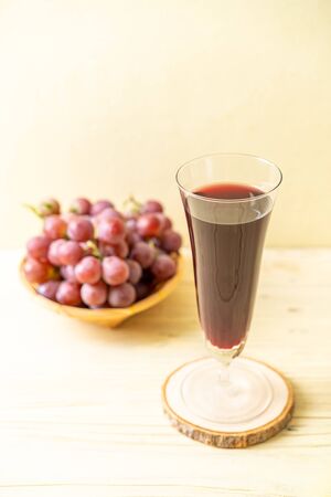 fresh grape juice on wood backgroundの写真素材
