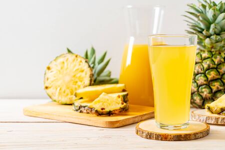 fresh pineapple juice on wood backgroundの写真素材