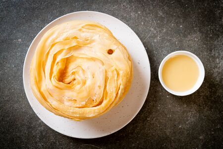 fried crispy roti dough with sweetened condensed milkの写真素材