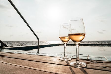 whiskey glass with swimming pool and sea background - selective focus pointの写真素材
