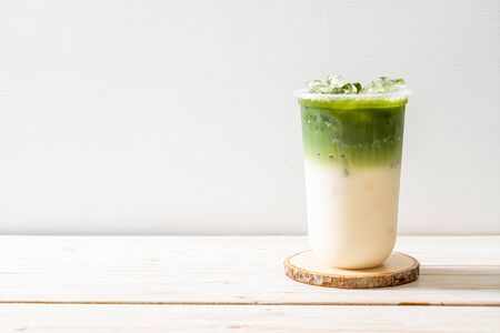iced matcha latte green tea on wood backgroundの写真素材