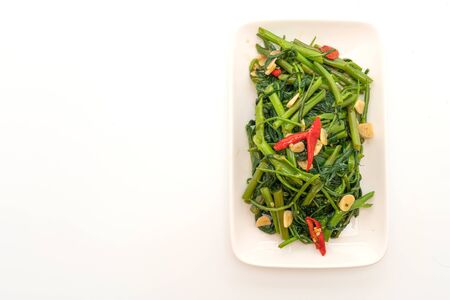 Stir-Fried Chinese Morning Glory or Water Spinach isolated on white backgroundの写真素材
