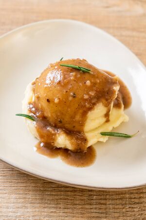 homemade mashed potatoes with gravy sauceの写真素材