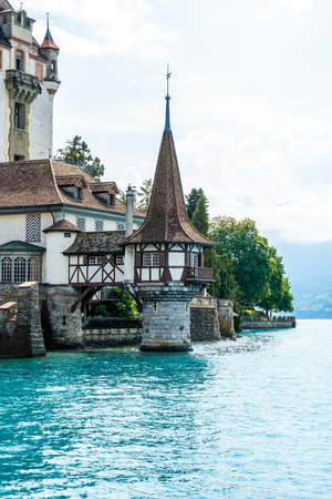 Beautiful Architecture at Oberhofen Castle with Thun Lake background in Switzerlandのeditorial素材