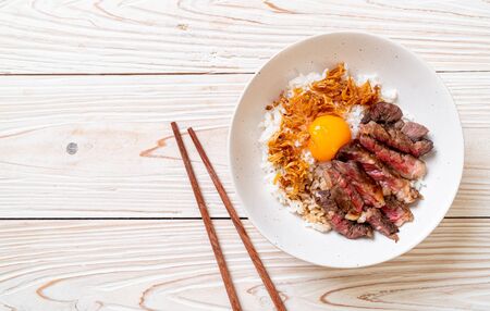 sliced beef on topped rice bowl with egg - Japanese food styleの写真素材