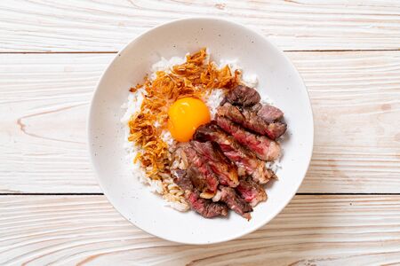 sliced beef on topped rice bowl with egg - Japanese food styleの写真素材