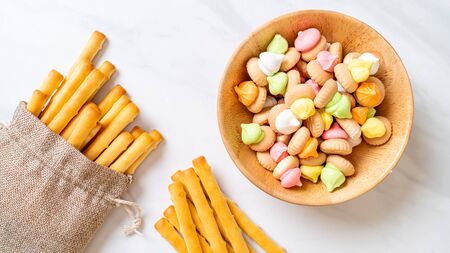 biscuit sticks with colorful sugar biscuit in bowlの写真素材