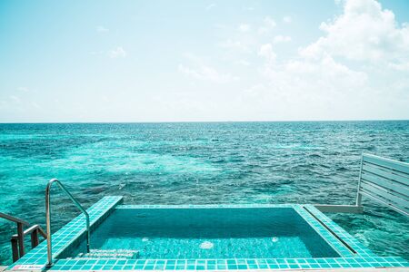 swimming pool with ocean and sea background in Maldives