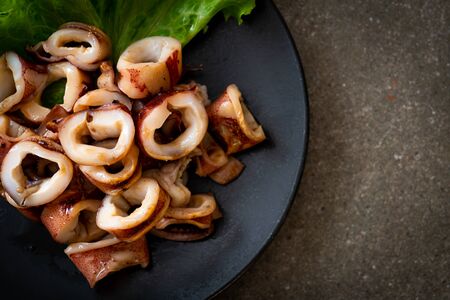 grilled squid on black plateの写真素材