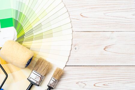 sample colors catalogue or colour swatches book with paint roller brush