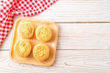 sponge cup cake with cheese on wood backgroundの写真素材