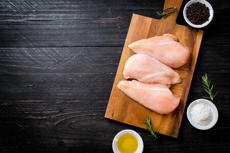 fresh chicken breast raw on cutting boardの写真素材