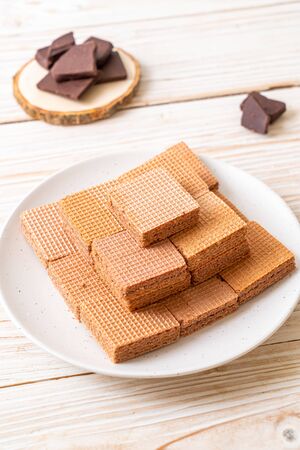 chocolate wafers with chocolate cream on wood backgroundの写真素材