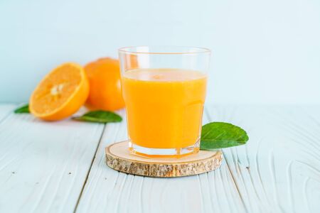 Fresh orange juice on woodの写真素材