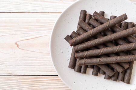 chocolate wafers stick roll on wood backgroundの写真素材