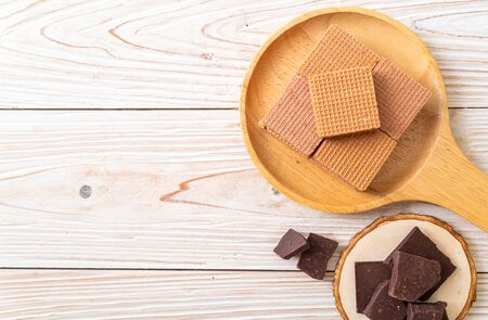 chocolate wafers with chocolate cream on wood backgroundの写真素材