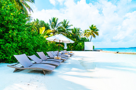 beach chair with tropical Maldives resort hotel island and sea backgroundのeditorial素材