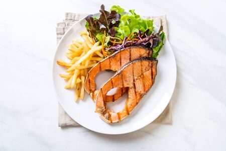 double grilled salmon steak fillet with french friesの写真素材