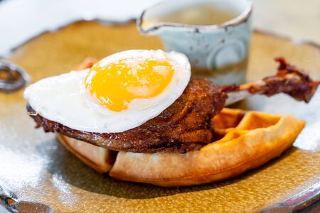 duck and waffle with fried eggの写真素材