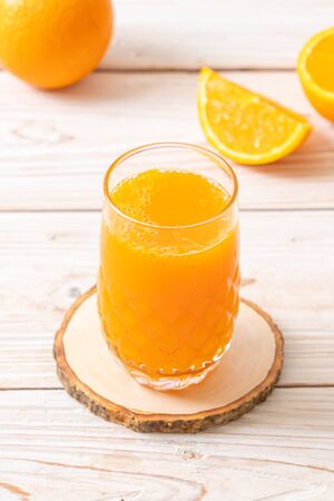 fresh orange juice glass on wood backgroundの写真素材