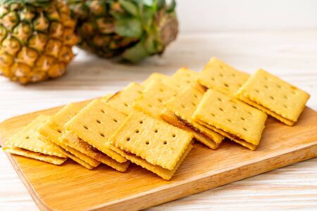 cheese biscuits with pineapple jam on wood backgroundの写真素材