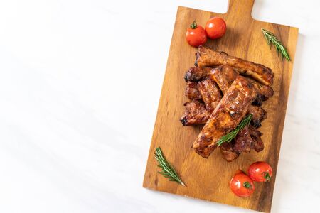 grilled barbecue ribs pork with rosemary and tomatoesの写真素材