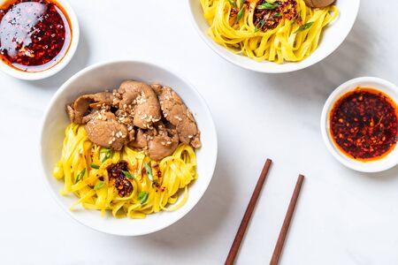asian stir-fried noodle with pork and chili pasteの写真素材
