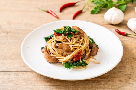 stir-fried spaghetti with chicken and basil - fusion food styleの写真素材