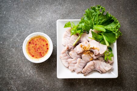 Boiled fish dip with sauce and vegetableの写真素材