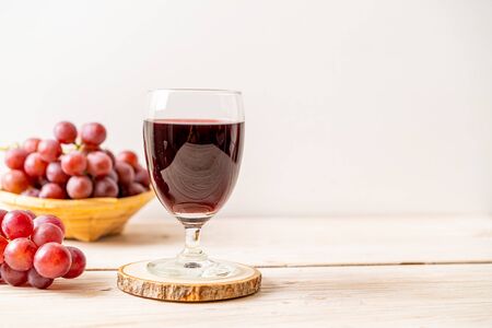 fresh grape juice on wood backgroundの写真素材
