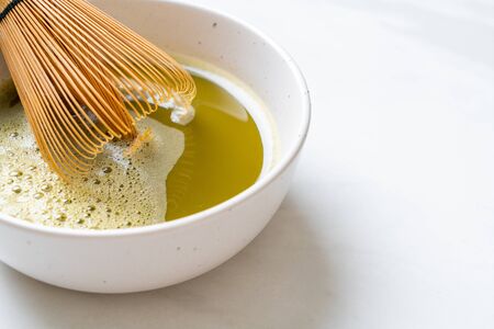 Matcha green tea cup with green tea powder and bamboo whiskの写真素材