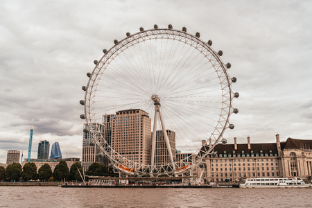 London/UK - September 2, 2019: London Eye with Thames river in London, United Kingdom.のeditorial素材