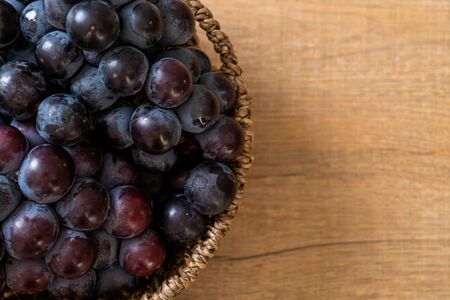 fresh black grapes in basket