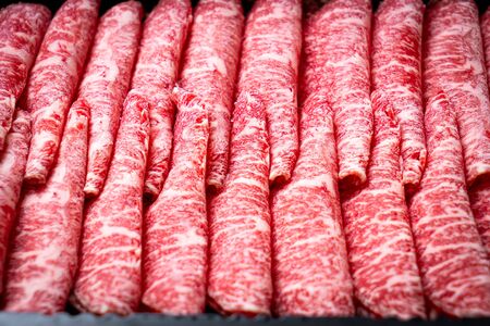 fresh beef raw sliced with marbled texture served for Sukiyaki and Shabu or Yakinikuの写真素材