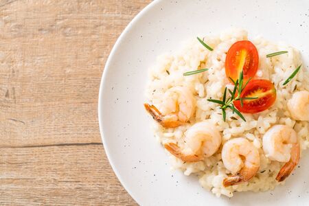 italian risotto with shrimps on white plateの写真素材