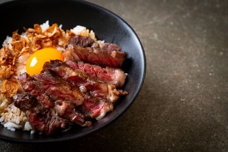 sliced beef on topped rice bowl with egg - Japanese food styleの写真素材