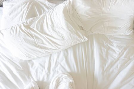 Messy bed, White pillow with blanket on bed unmade