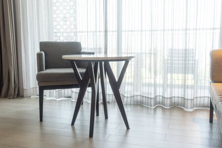 empty chair and table in living room with curtain backgroundの写真素材