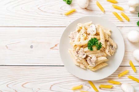 penne pasta carbonara cream sauce with mushroom - Italian food styleの写真素材