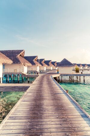 Beautiful tropical Maldives resort hotel and island with beach and sea  - boost up color processing styleの写真素材