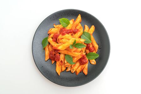 Penne pasta in tomato sauce isolated on white backgroundの写真素材