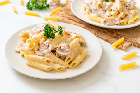 penne pasta carbonara cream sauce with mushroom - Italian food styleの写真素材