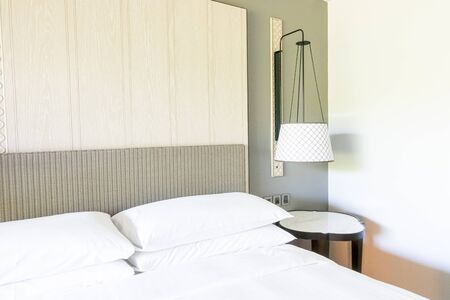 white pillows decoration on bed in bedroomの写真素材