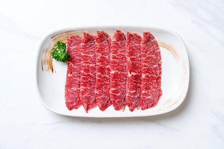 fresh beef raw sliced with marbled texture served for Sukiyaki and Shabu or Yakinikuの写真素材